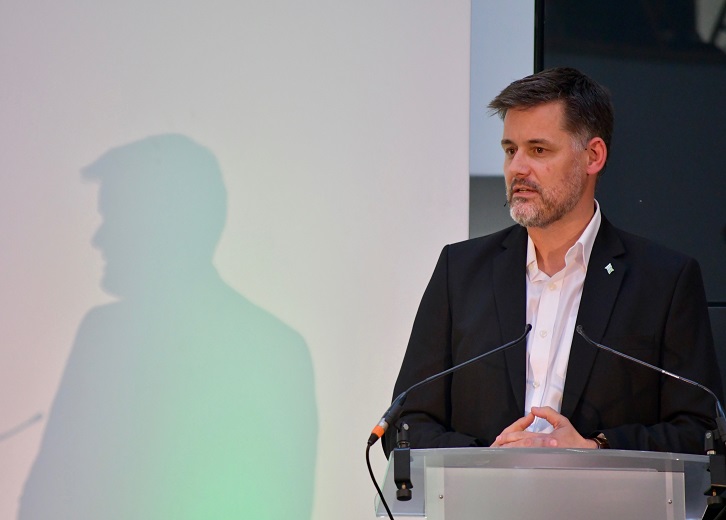 David Owen gives a talk from a podium