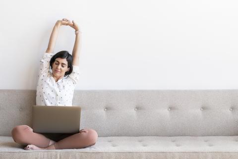 woman sits on sofa